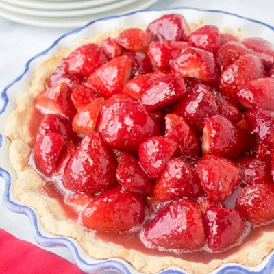 Close-up of fresh strawberry pie in blue-rimmed ceramic pie plate.