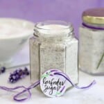 Hexagonal glass jar filled with lavender sugar, with a hand-written lavender sugar label propped in front.