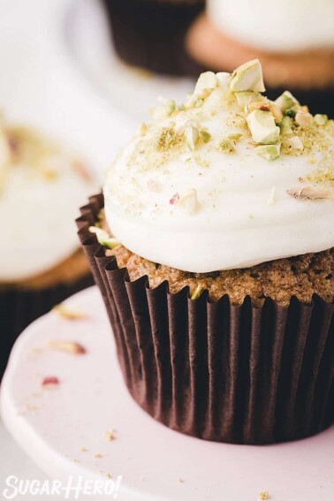 Close-up of zucchini cupcake with big dollop of cream cheese frosting on top.