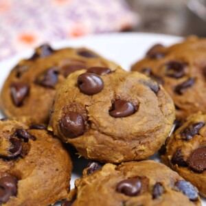 3-Ingredient Pumpkin Chocolate Chip Cookies on a white plate in a stack.