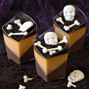 Three 2oz Chocolate Orange Panna Cotta with skull and bone sprinkles.