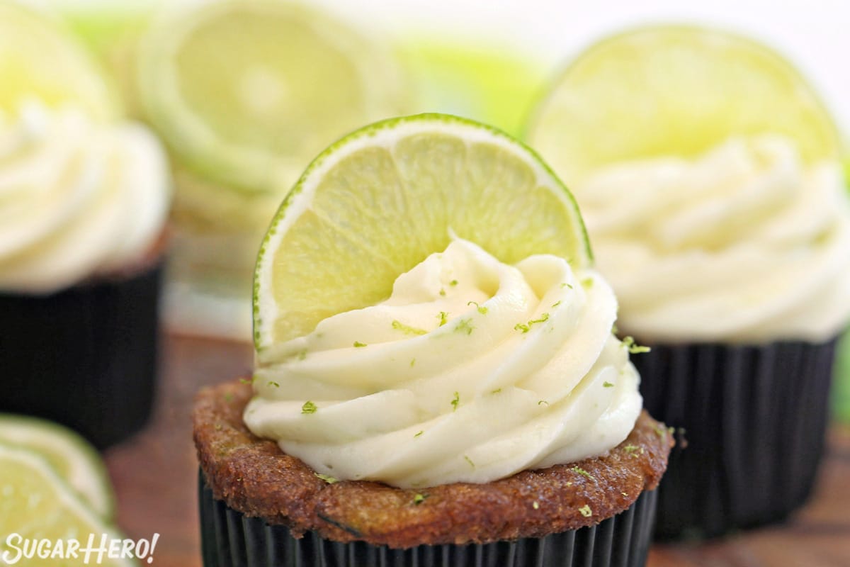 Cupcake with cream cheese frosting and half a lime slice on top.