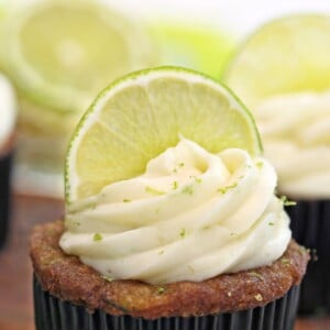 Close-up of lime frosting on top of a cupcake with half a lime slice embedded in top.
