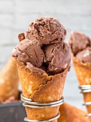 Close up of 3 scoops of No-Churn Chocolate Ice Cream in a waffle cone in a silver cone holder.