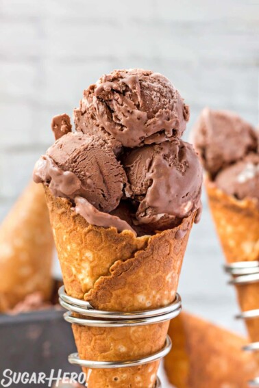 Close up of 3 scoops of No-Churn Chocolate Ice Cream in a waffle cone in a silver cone holder.