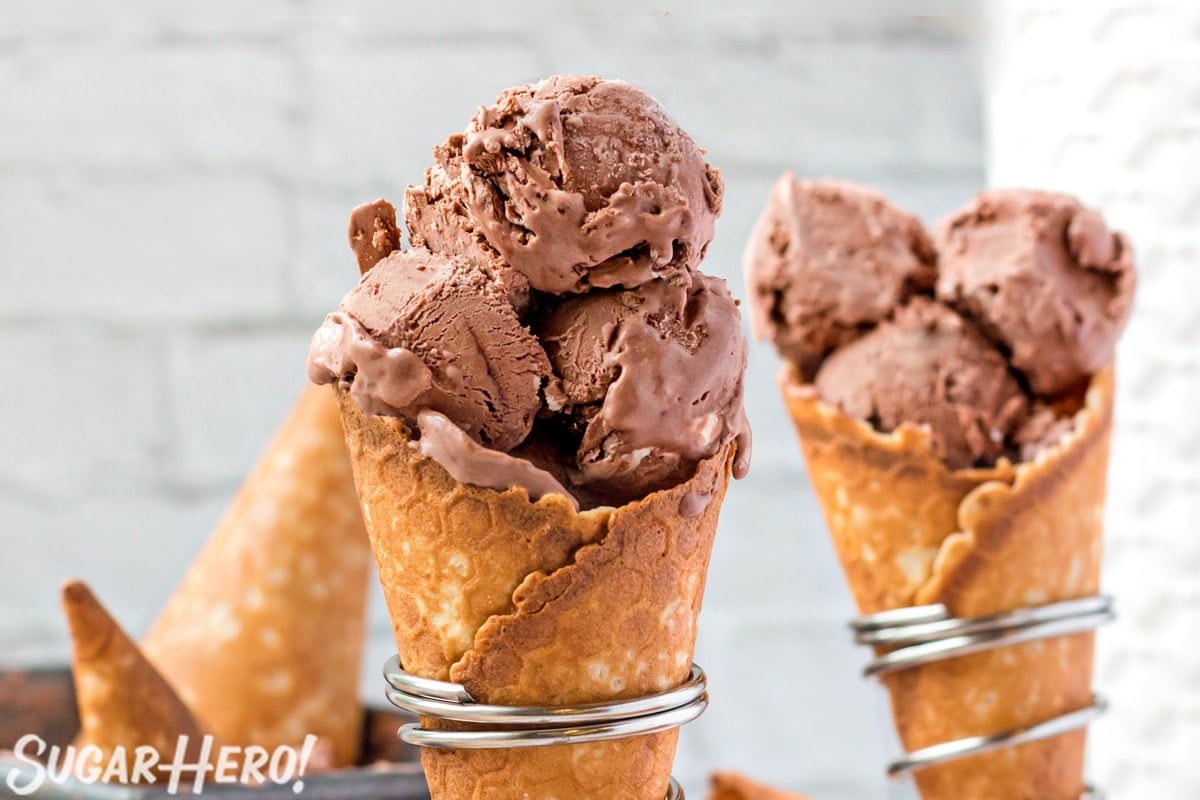 2 waffle cones with 3 scoops of No-Churn Chocolate Ice Cream in silver cone holders.