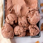 Close up of 6 scoops of No-Churn Chocolate Ice Cream in a silver container.