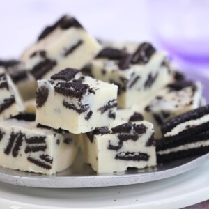 Several pieces of Oreo fudge cut in cubes on a silver plate.