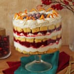 Cranberry Orange Trifle in a clear glass trifle bowl on an aqua colored napkin.