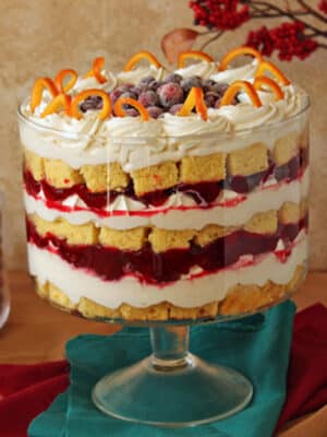 Cranberry Orange Trifle in a clear glass trifle bowl on an aqua colored napkin.