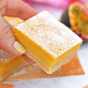 Close up of Passion Fruit Bar held by a hand.