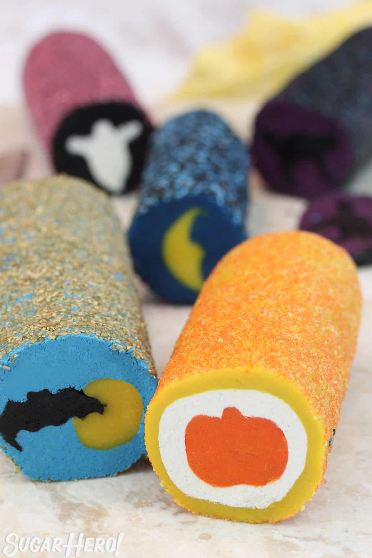 5 rolls of Slice and Bake Halloween Cookies on a marble surface.