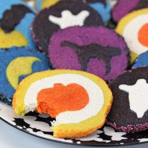 Plate of baked Slice and Bake Halloween Cookies with a bite taken out of the front cookie.