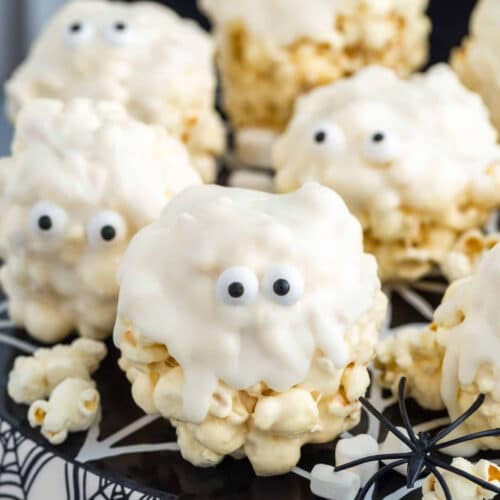 Close up of Marshmallow Ghost Popcorn Balls on a Halloween plate.