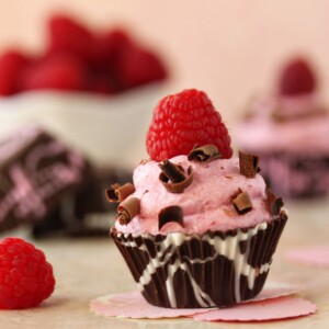 Close up of Raspberry Mousse Chocolate Cup with a raspberry on top.