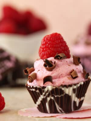 Close up of Raspberry Mousse Chocolate Cup with a raspberry on top.
