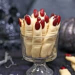 Witch Finger Cookies standing upright in a clear glass.