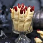 Witch Finger Cookies standing upright in a clear glass.