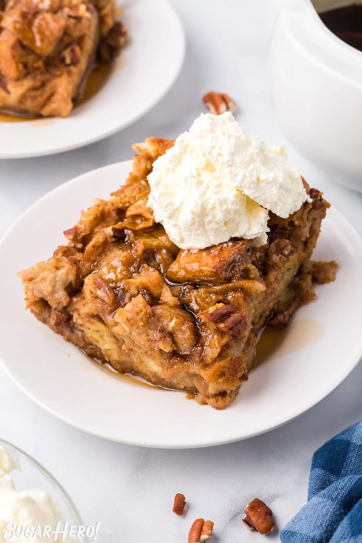 Slice of Pumpkin Bread Pudding with a scoop of whipped cream on top.