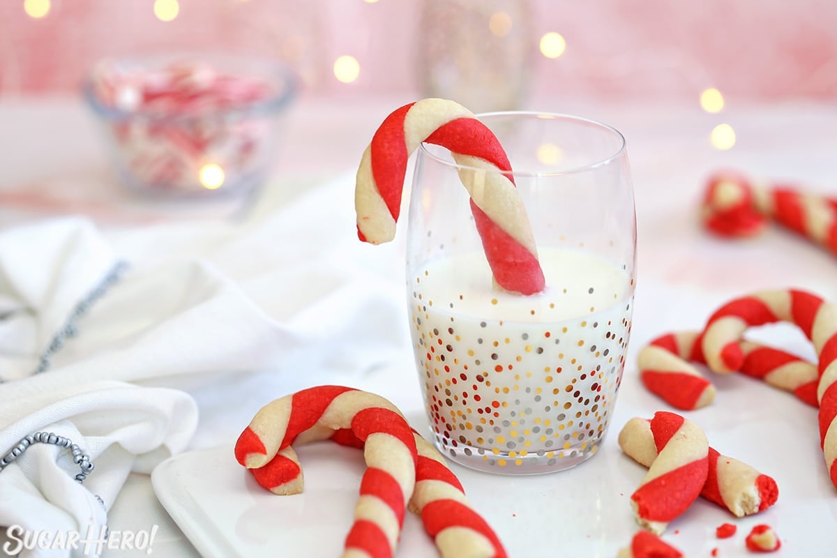 Platter of Candy Cane Cookies, with one dunked in a glass of milk.