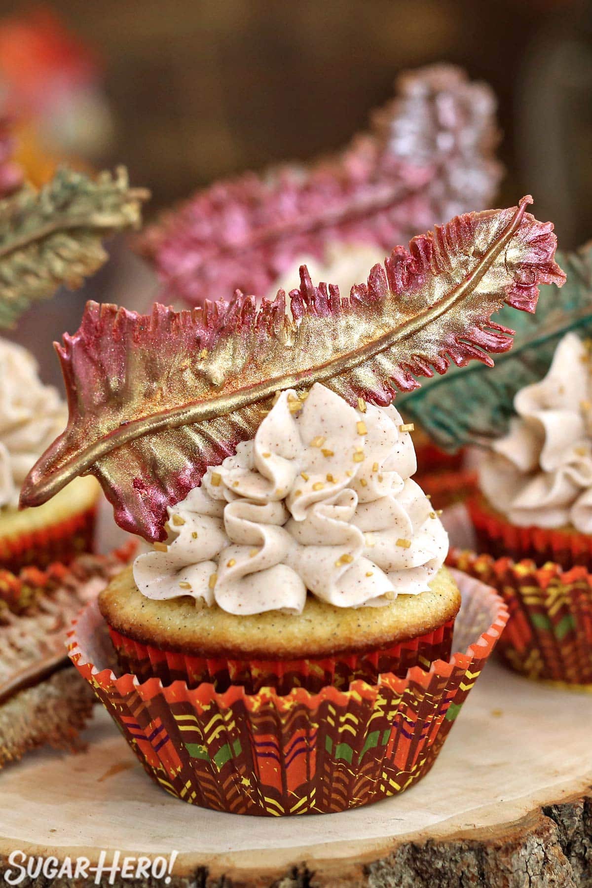 Spice Cupcake with a fall-colored cupcake wrapper and a chocolate feather on top.