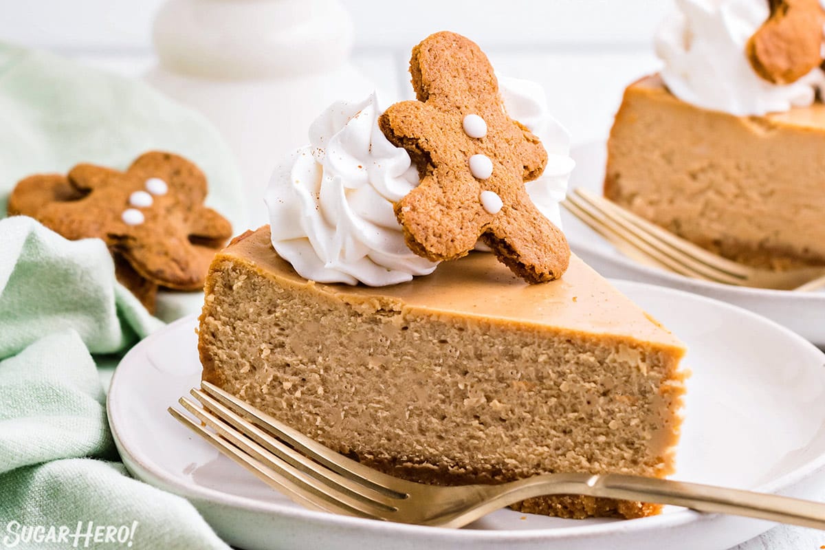 Slice of Gingerbread Cheesecake on a white plate next to a fork.