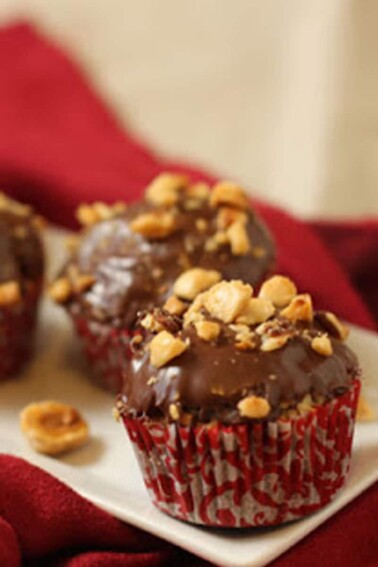 Four-Ingredient Nutella Cupcakes sitting on a white rectangular platter on a red napkin.