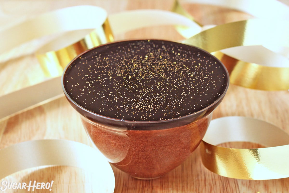 Salted Caramel Chocolate Mousse in a copper bowl, covered with chocolate gelee and gold disco dust.