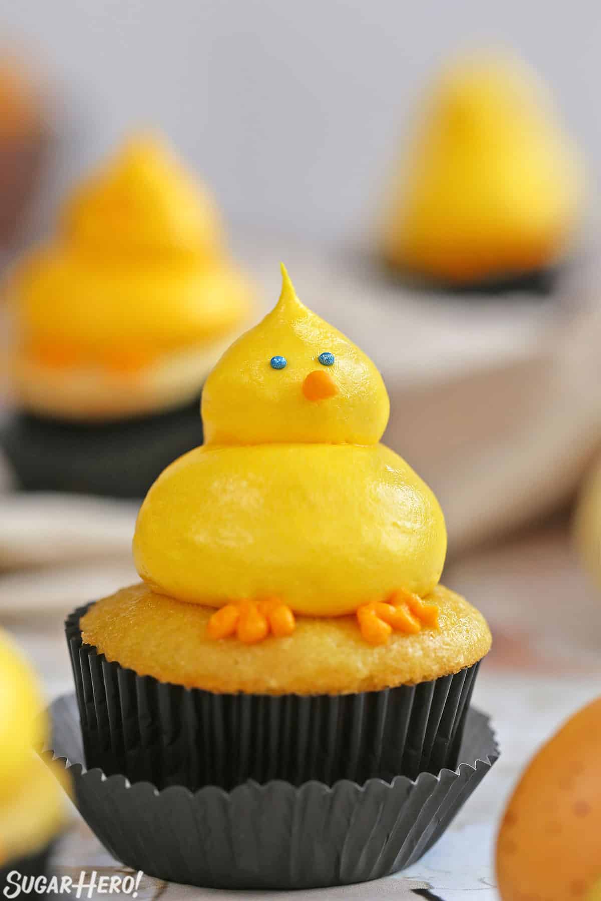 Close up of a Baby Chick Cupcake on a marble surface.