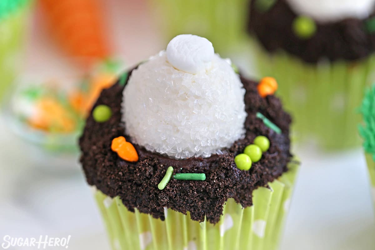 Close up of a Bunny Butt Cupcake with Oreo crumb dirt and Easter sprinkles on top.