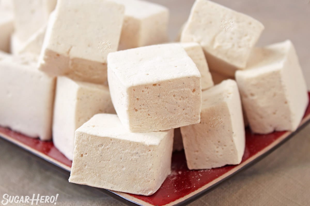 Vanilla bean marshmallows on a red platter.
