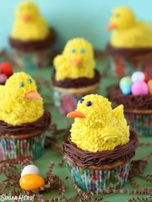 5 Spring Chick Cupcakes on a green surface.