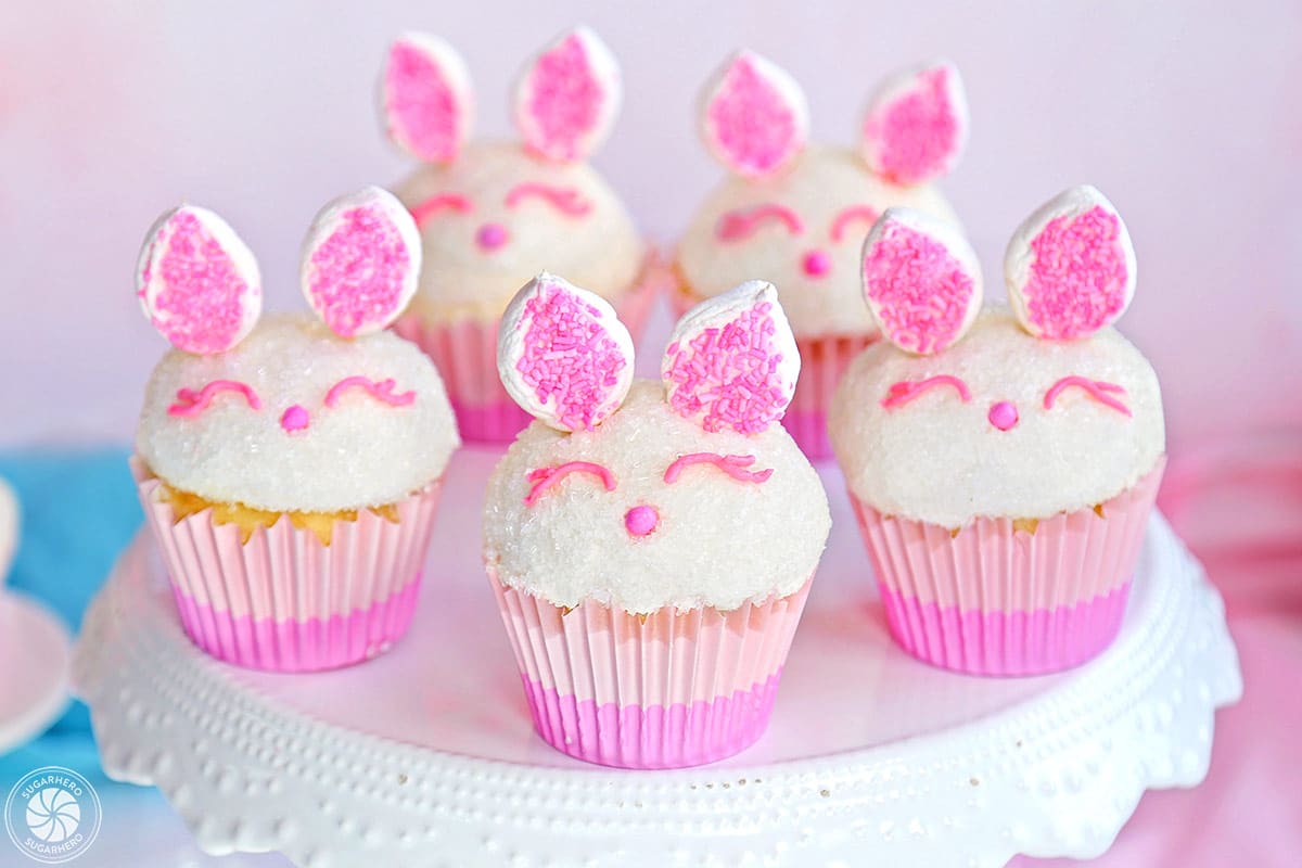 5 Easter Bunny Cupcakes on a white cake stand.