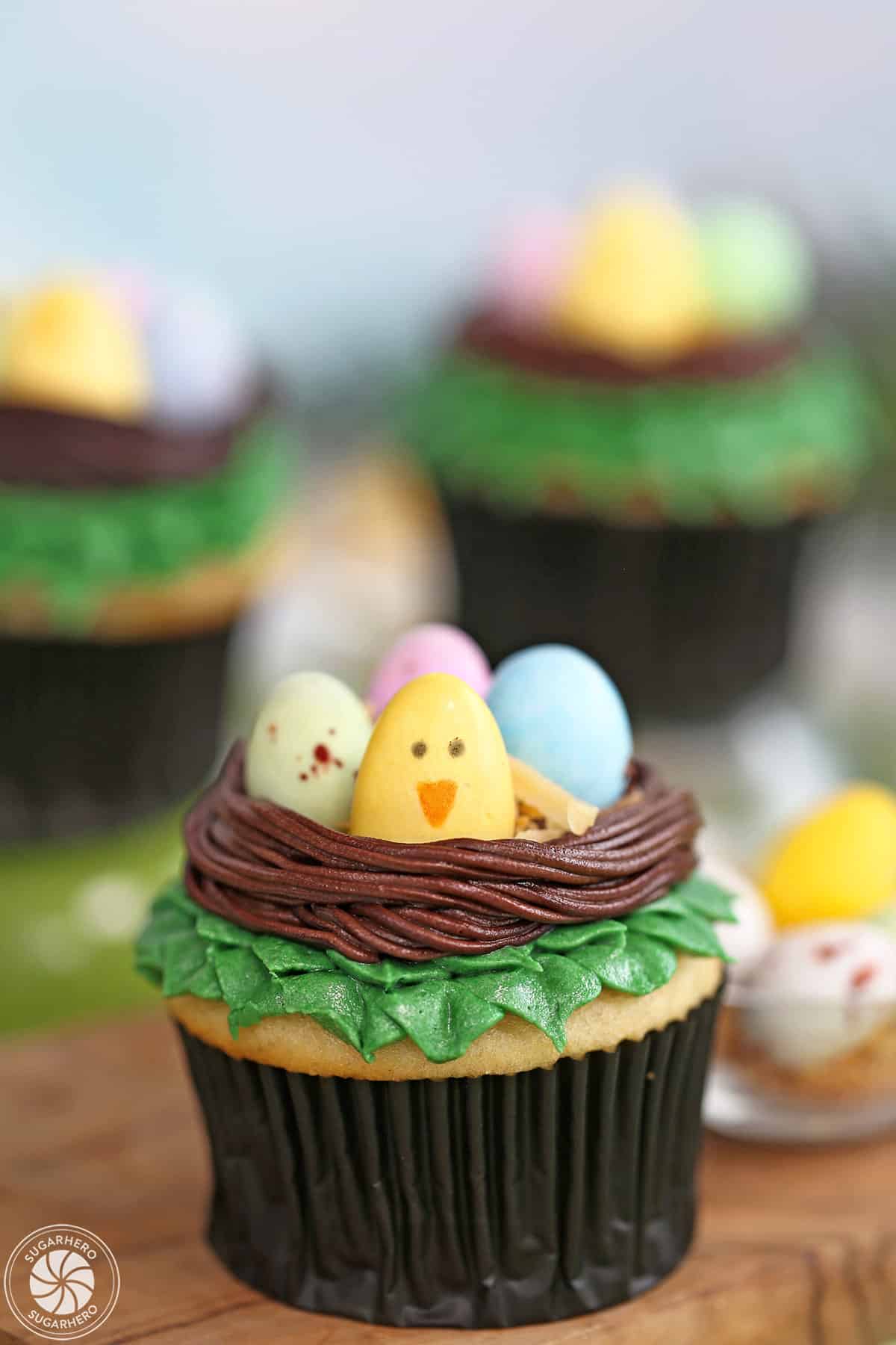 Three Easter Bird's Nest Cupcakes with chocolate eggs in the nest.