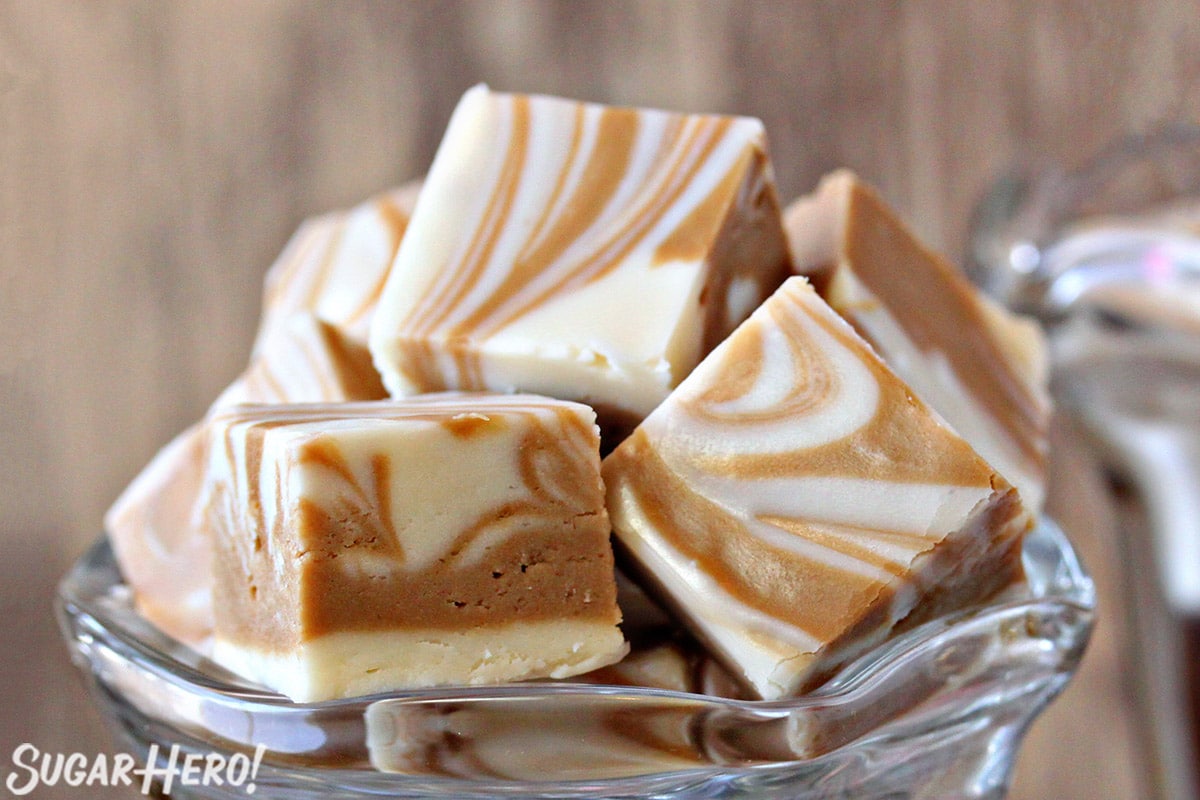 Swirled root beer fudge squares in a fluted bowl.
