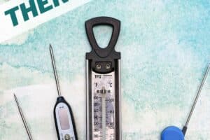 Overhead shot of four thermometers on a blue-green background, with text overlay for Pinterest.