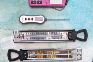 Overhead shot of five candy thermometers, with text overlay for Pinterest.