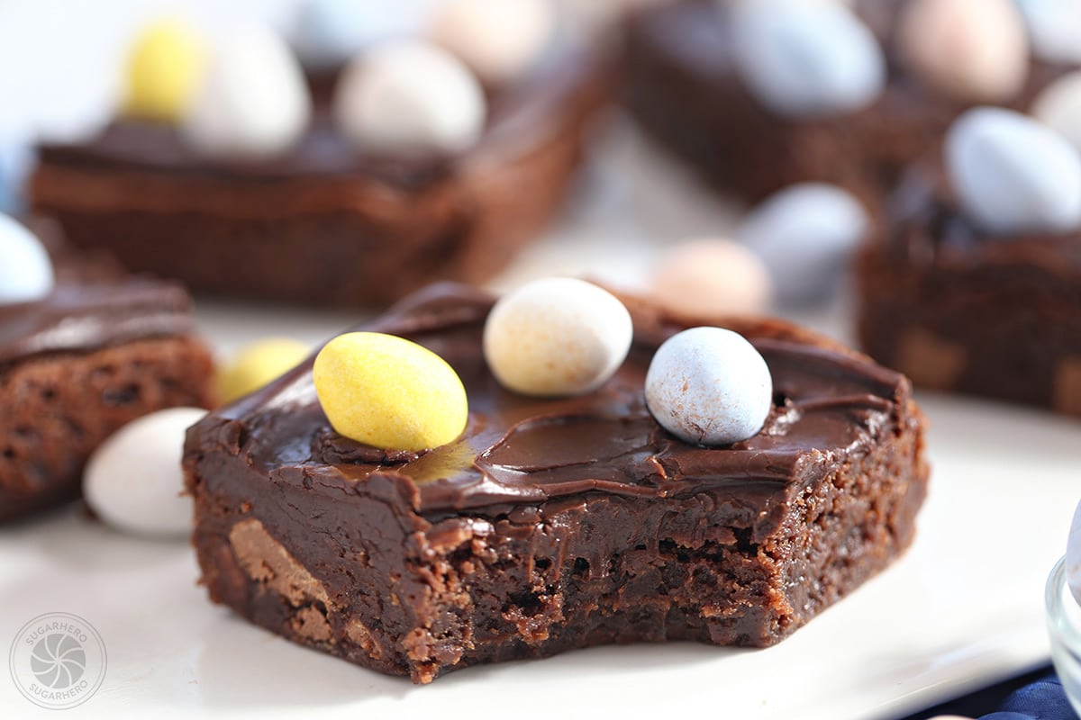 Close-up of an Easter Egg Brownie with Cadbury mini eggs on top and a bite taken out of it.