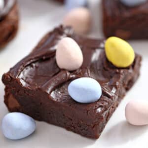Easter Egg Brownies on a white plate with Cadbury mini eggs on top and next to it.