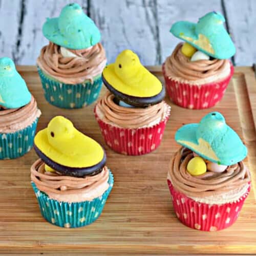 6 Peeps Cupcakes on a wooden cutting board for Easter Cupcake Round up.