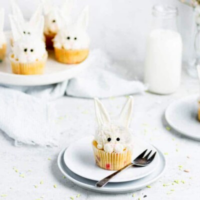 Single Vanilla Coconut Bunny Cupcake on a white plate for the Easter cupcake round up.
