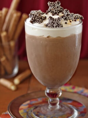Glass of Frozen Hot Chocolate with star cookies on top.