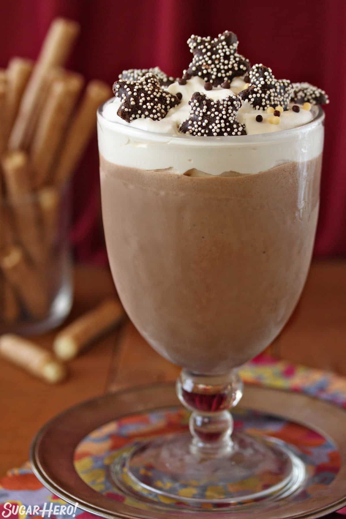 Frozen Hot Chocolate | SugarHero.com Glass of Frozen Hot Chocolate with star cookies on top.