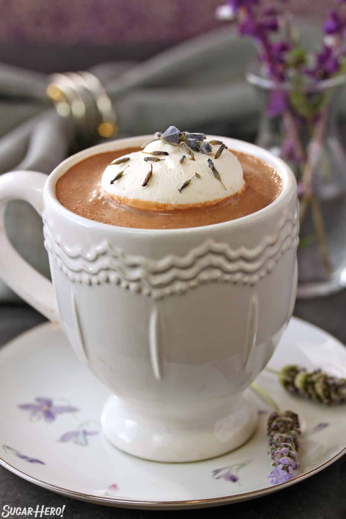 Lavender Hot Chocolate | SugarHero.com Close up of a white mug of Lavender Hot Chocolate.