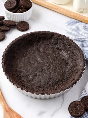 Close up of an Oreo Pie Crust in a silver pie pan.