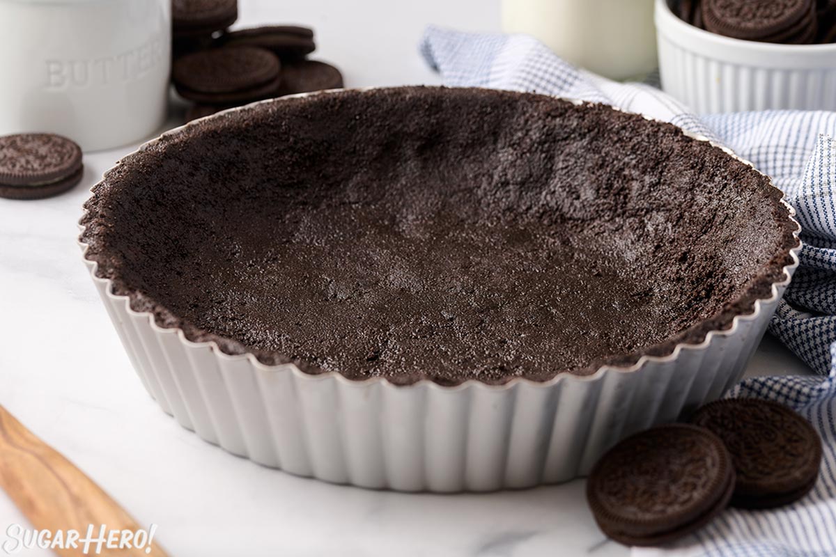 Close up of an Oreo Pie Crust in a silver pie pan.