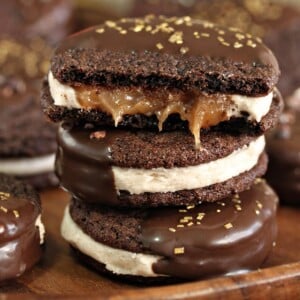 Close up of a stack of Spicy Chocolate Caramel Sandwich Cookies showing buttercream and gooey caramel.