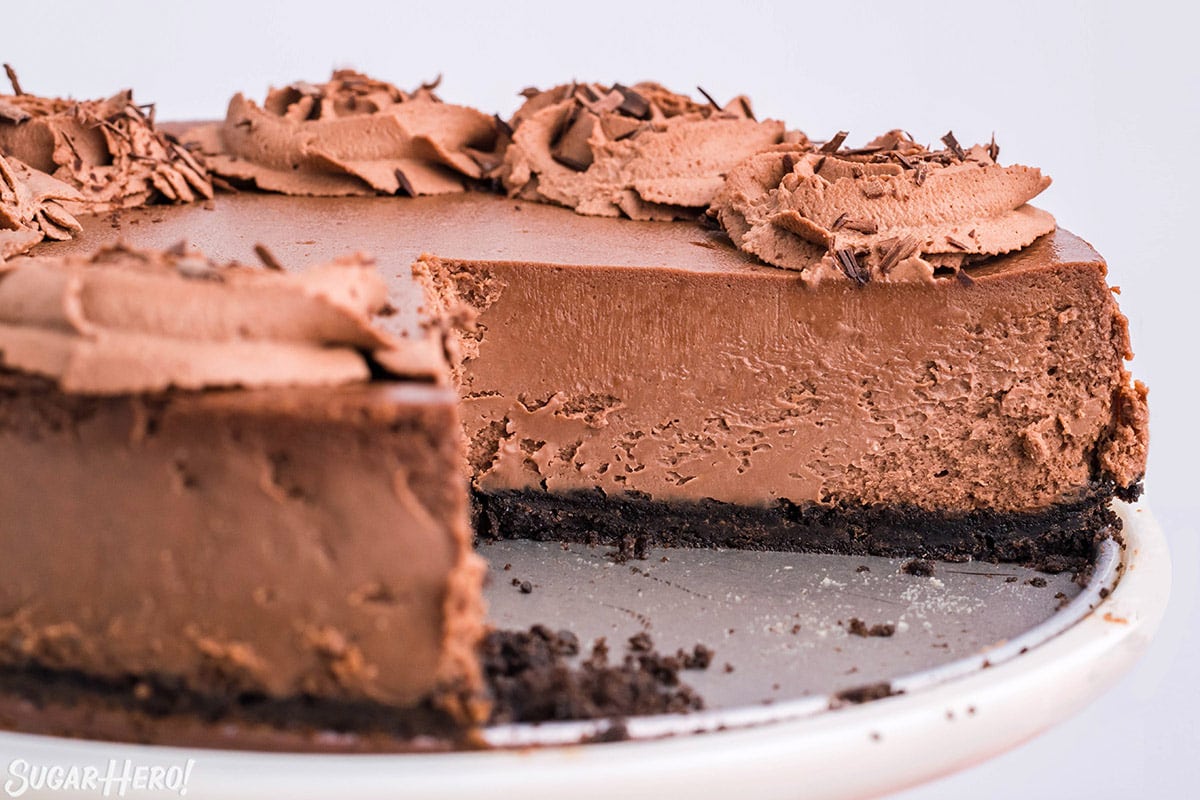 Close up of a Chocolate Cheesecake with a slice removed to show internal texture.