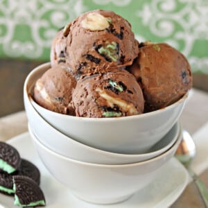 Several scoops of Chocolate Mint Swirl Ice Cream in a white bowl.