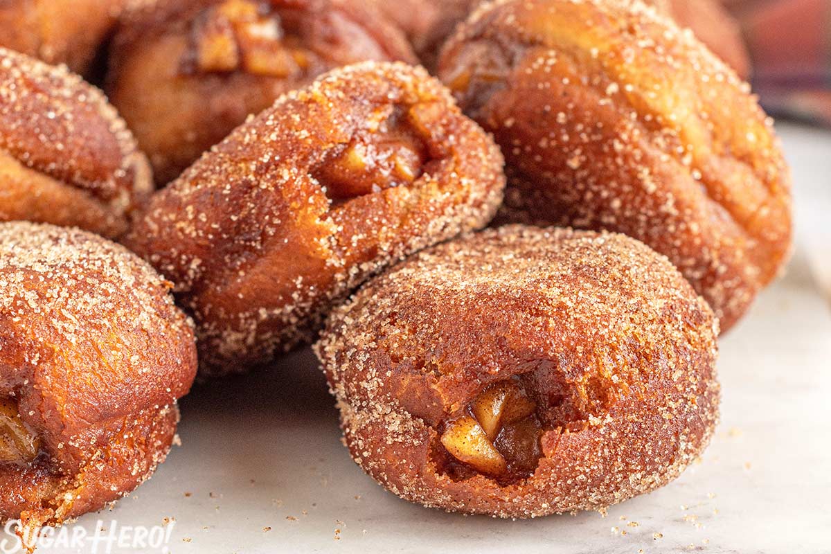 Close-up of a group of Apple Donuts on a marble surface.